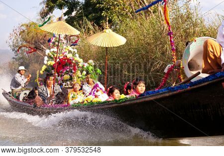 INLE LAKE, MYANMAR - CIRCA FEBRUARY 2018: Widding boat with traditionaly dressed people on the Inle Lake in Myanmar.