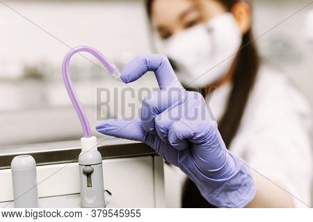 Dental Treatment, Healthcare And Dentistry Concept. The Womans Hand Shows The Heart Together With Th