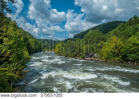 A Whitewater Raft And A Few Kayaks Going Down The Fast Current Of The Ocoee River In Tennessee With 