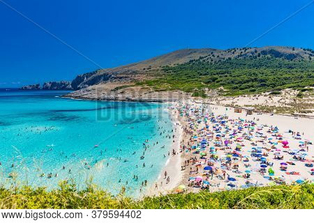 CALA MESQUIDA, MALLORCA, SPAIN - 19 July 2020: People enjoying beautiful sandy beach of on Mallorca, Mediterranean Sea, Balearic islands, Spain.