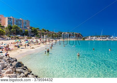 PORT ADRIANO, MALLORCA, SPAIN - 23 July 2020 - Tourists enjoying summer day on the popular city beach.
