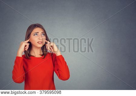 Portrait Young Annoyed, Unhappy Stressed Woman Covering Her Ears, Looking Up, To Say, Stop Making Lo