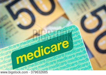Australian Medicare card over blurred money background.
