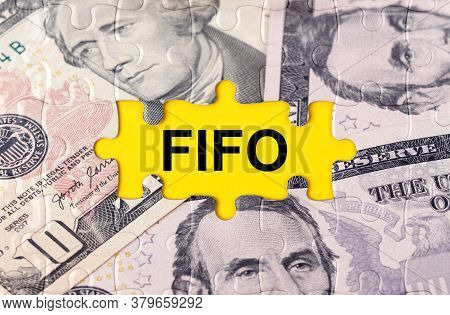 Business Concept. Puzzle With The Image Of Dollars In The Center Of The Inscription -fifo