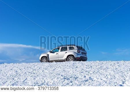 Vik,iceland - March 5, 2020: Silver Car Duster Dacha On The Road Against The Background Of Blue Sky 