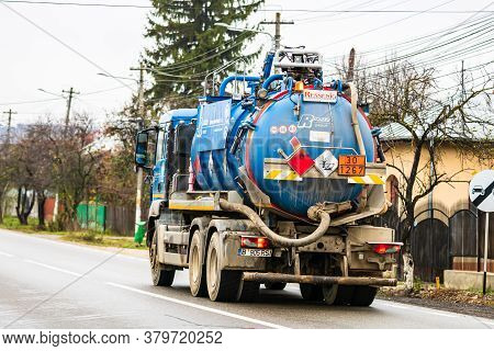 Cars On The Asphalt Road. Utility Car (from Rohrer Group Company) In Traffic.  Targoviste, Romania, 