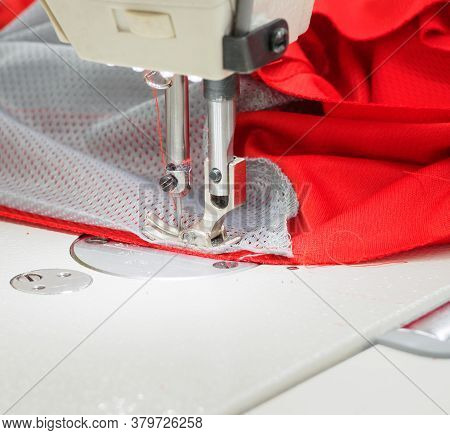 Close Up Of Sewing Process On The Overlock In The Sewing Shop. Tailoring Industry.. Interior Of Garm