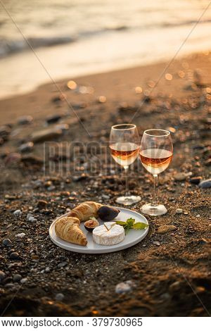 Beach Picnic With Rose Wine, Croissants, Camamber Cheese And Figs. Negative Space.