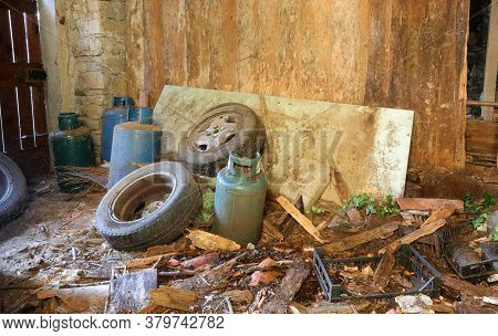 Homeless Shelter With Old Tires Garbage And Empty Gas Cylinders