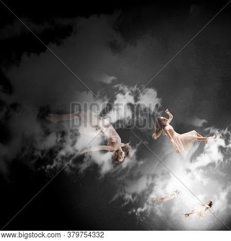 Mid-air Beauty Cought In Clouds. Full Length Shot Of Attractive Young Woman Hovering In Air And Keep