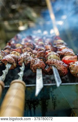 Skewers Uncooked In Nature On Skewers In The Open Air. Shish Kebab On The Nature Raw On The Grill On