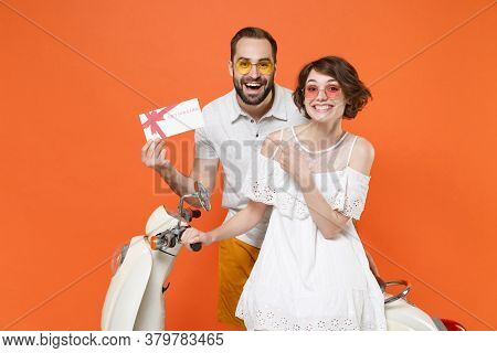 Excited Young Couple Friends Guy Girl In White Summer Clothes Glasses Sit On Moped Isolated On Orang