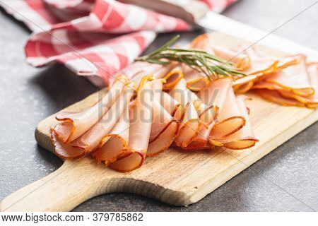 Dried spanish ham. Lomo embuchado on cutting board.