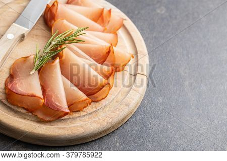 Dried spanish ham. Lomo embuchado on cutting board.