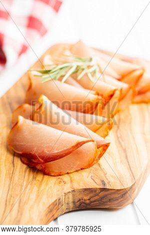 Dried spanish ham. Lomo embuchado on cutting board.