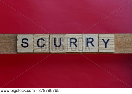 Text The Word Scurry From Gray Wooden Small Letters With Black Font On An Red Table