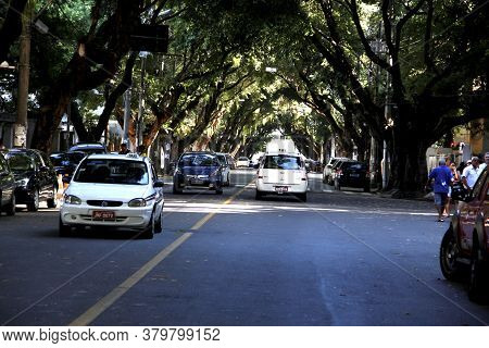 Salvador, Bahia / Brazil - March 23, 2013: Vehicles Are Seen On A Tree-lined Street In The Corredor 
