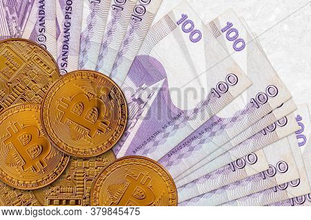 100 Philippine Piso Bills And Golden Bitcoins. Cryptocurrency Investment Concept. Crypto Mining Or T