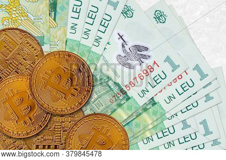 1 Romanian Leu Bills And Golden Bitcoins. Cryptocurrency Investment Concept. Crypto Mining Or Tradin