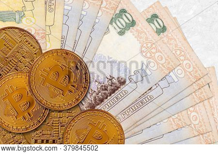 100 Ukrainian Hryvnias Bills And Golden Bitcoins. Cryptocurrency Investment Concept. Crypto Mining O