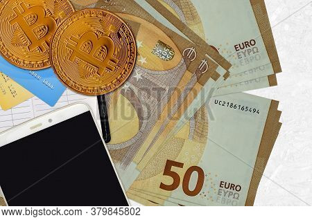 50 Euro Bills And Golden Bitcoins With Smartphone And Credit Cards. Cryptocurrency Investment Concep