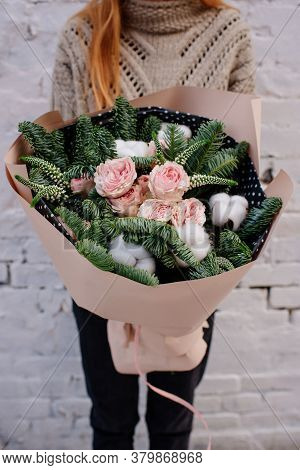 Bouquet Of Flowers And Fir Branches And Cottonwood Boxes In Peach Package In The Hands Of Woman Flor