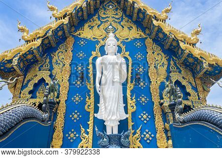 Chiangrai, Thailand - June 7, 2020: Standing White Buddha On Yellow Blue Wat Rong Suea Ten Church Ba