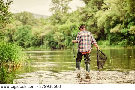 Calling Fly-fishing A Hobby. Fisherman With Fishing Rod. Retired Bearded Fisher. Trout Bait. Hobby A