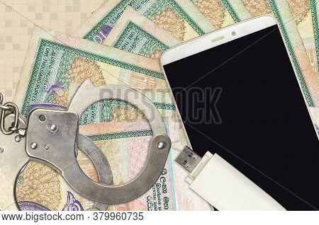 1000 Sri Lankan Rupees Bills And Smartphone With Police Handcuffs. Concept Of Hackers Phishing Attac