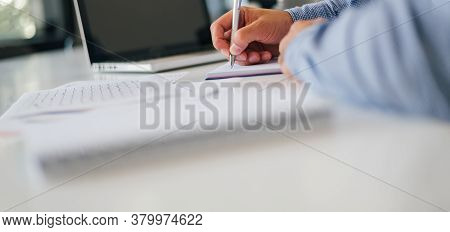 Close Up Of Businessman Entrepreneur Hand Taking Notes Holding Using Pencil Pen In Modern Bright Off