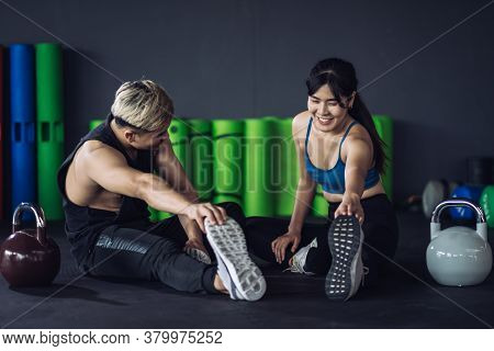 Healthy Two People Young Asian Doing Stretching Leg After Workout At Fitness Gym, Cooldown Muscle He