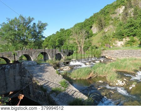 Roman Stone Bridge Over River Ulzama In Trinidad De Arre, Navarra, Spain: Stone Bridge, Waterfalls, 