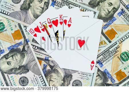 Playing Cards On Us Dollars Background. Close Up Of A Lot Of Banknotes Hundred Dollar Bills. America