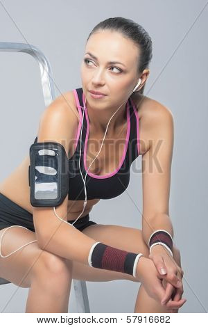 Fit Young Woman Concentrated On Music