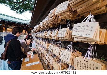 Tokyo, Japan - November 23, 2013 : People Writting Ema Plaques At A Meiji Jingu Shrine, Tokyo, Japan