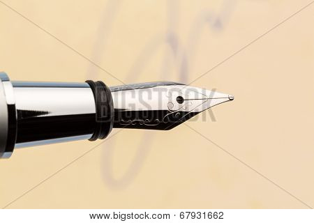 a signature and a fountain pen on yellow paper. symbolic photo for contract testament and graphology