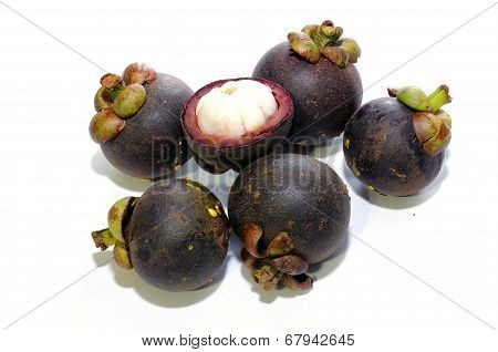 Mangosteen and one cut isolated on white
