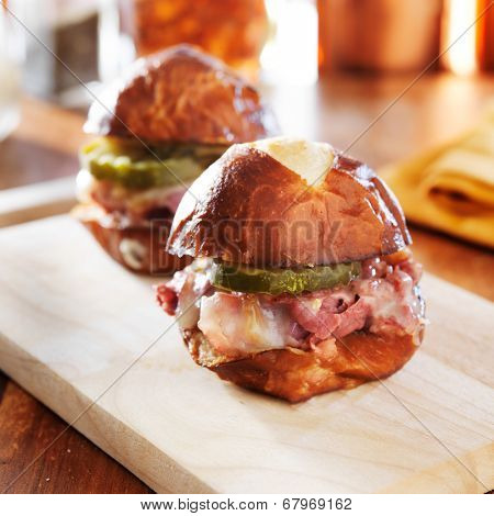 corned beef and cheese slider on pretzel bun