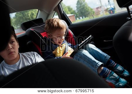 Two boys on the back seat of a car