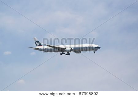 Cathay Pacific Boeing 777 in New York sky before landing at JFK Airport