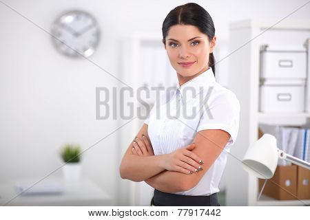 Attractive businesswoman with her arms crossed  standing in office