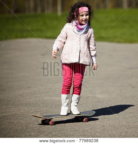 little girl skating on the street