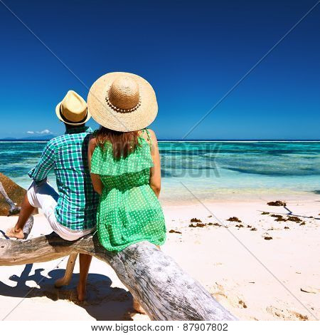 Couple relaxing on a tropical beach Anse Source d'Argent at Seychelles, La Digue. 