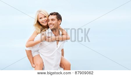 summer holiday, vacation, dating and tourism concept - happy couple having fun on the beach
