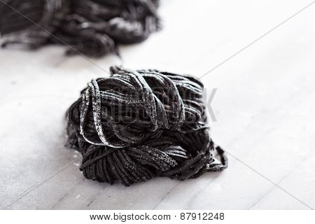Squid ink homemade pasta on marble
