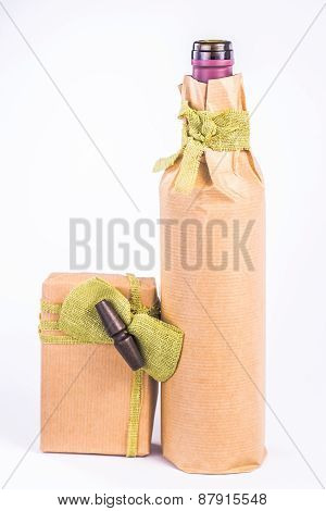 isolated bottle wrapped in paper with the box