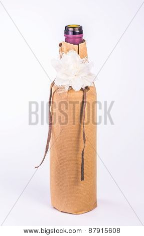 isolated bottle wrapped in paper with decoration