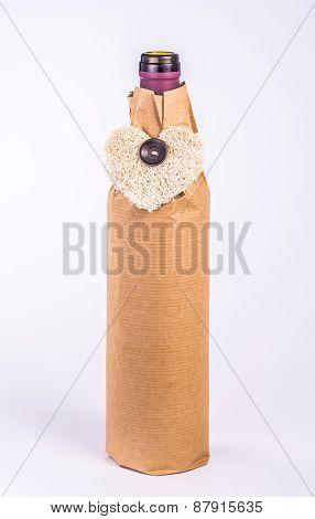 isolated bottle wrapped in paper with decorative heart