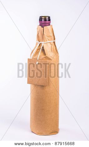 isolated bottle wrapped in paper with label