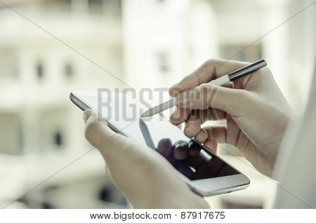 A woman using tablet with stylus pen